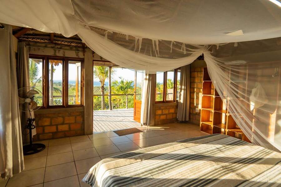 Bedroom with mosquito net and estuary view